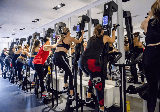 Group using exercise machines with BYE BYE, TOXIC AND SMELLY LUBRICANTS FOR EXERCISE EQUIPMENT – HELLO PLANETSAFE
