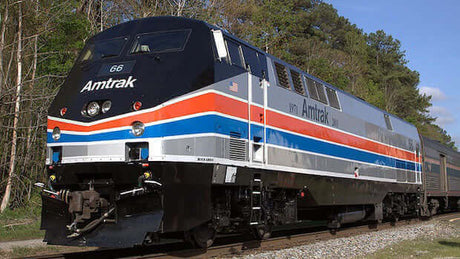 Amtrak train in Oakland, CA highlighting the approval of PlanetSafe AIM lubricant over competitors.