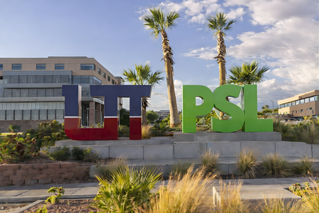 Alt Tag: Utah Tech campus sign with palm trees, featuring gym equipment lubricant PlanetSafe message