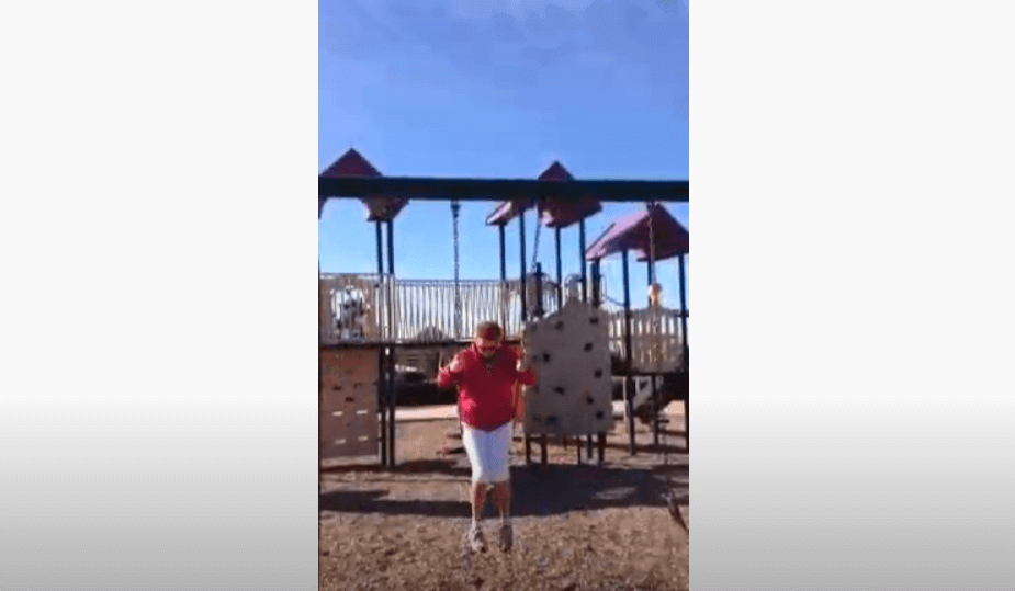Person swinging at a playground showcasing Stop Squeaking Swings - PlanetSafe AIM Quiets Squeaky Swings solution.