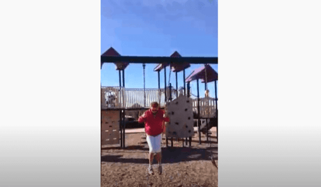 Person swinging at a playground showcasing Stop Squeaking Swings - PlanetSafe AIM Quiets Squeaky Swings solution.