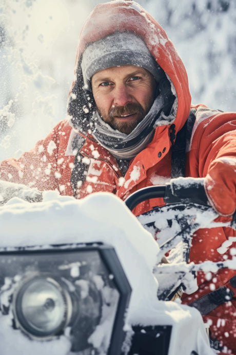 Man operating snow vehicle showcasing Discover Non-Toxic Cold-Resistant Lubrication Solutions for harsh winter conditions.