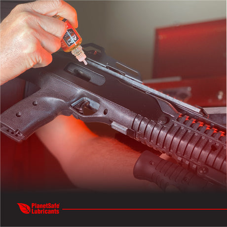 AiM Weapons Grade CLP Pistol Cleaner (2x1oz + 2 applicator bottles) applied to firearm for rust prevention and lubrication.